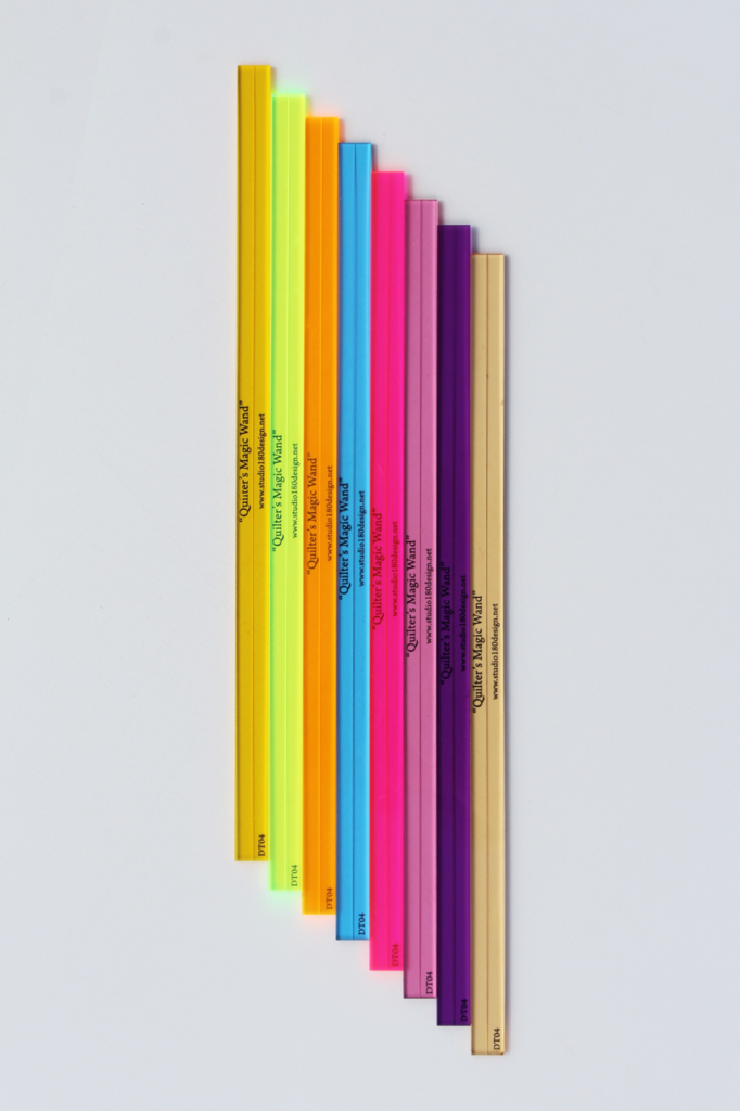 Quilter's Magic Wand An accurate 1/4" Seam Marking Guide with etched 1/4" line running down the middle - assorted colours - blue, green, orange, yellow, light pink, champagne, hot pink and purple.
