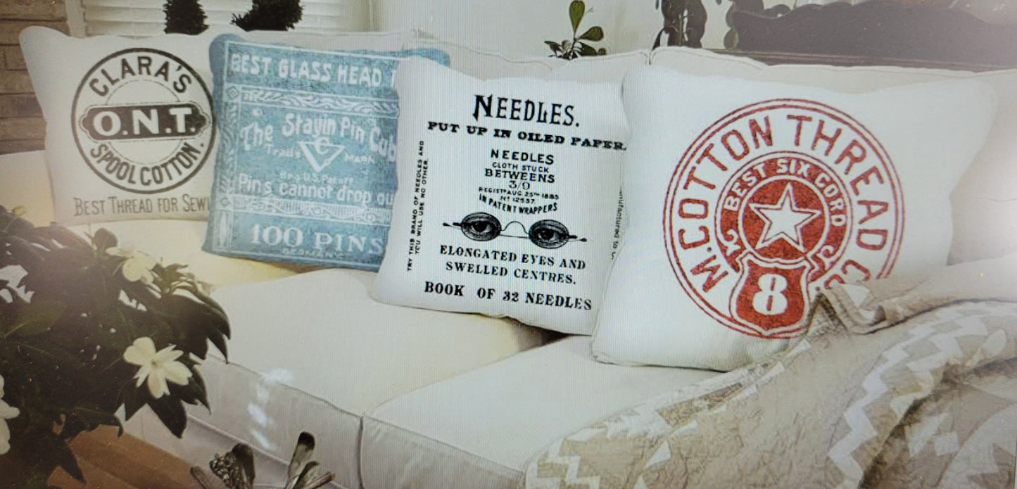 Decorative pillows with text and logos on a couch made from fabric panel.