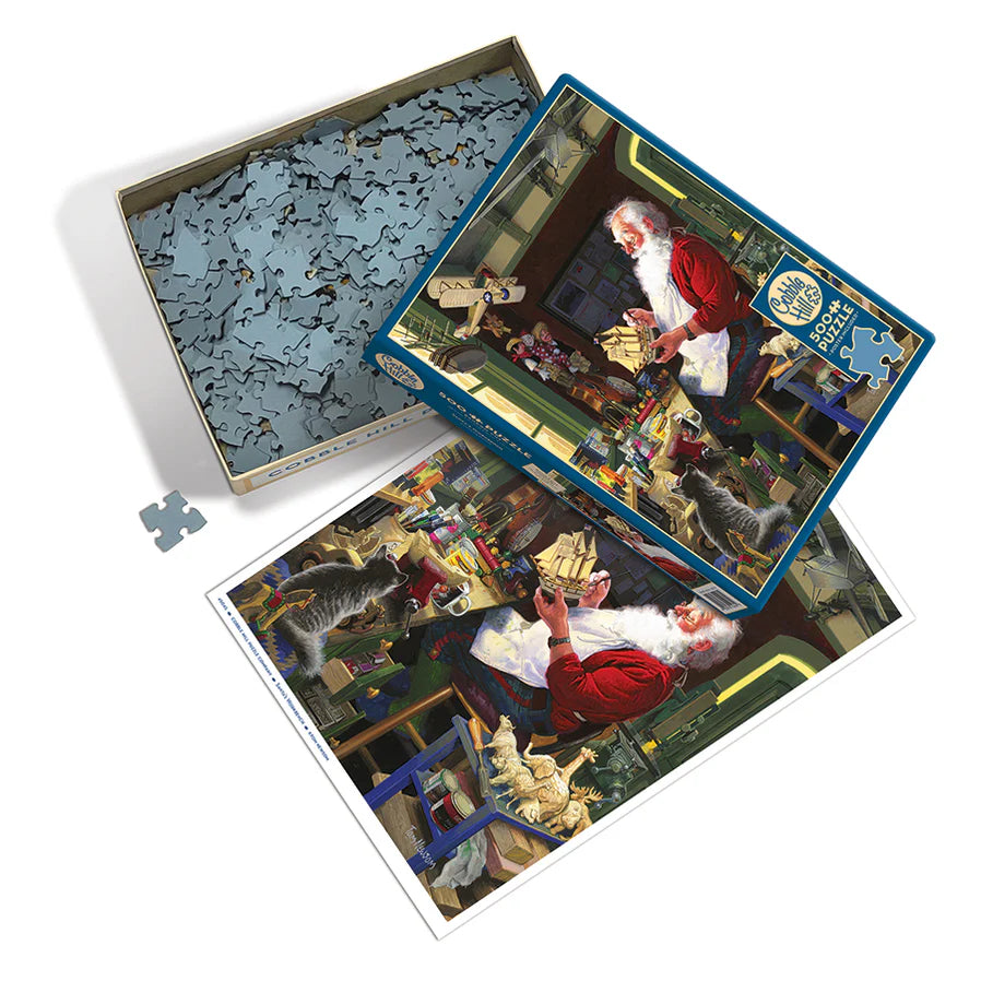 Santa's Workbench - 500 Piece
From Cobble Hill
At Santa's Work Bench we find good Ol' Saint Nick's attention taken up with the painting of his sailboat. Will the wooden animals get painted before Christmas? It looks like he already has a wooden train painted and another boat being built. Santa is a busy man!