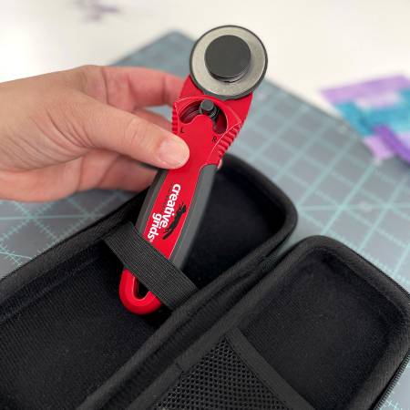 The Creative Grids® 45mm rotary cutter is designed with you in mind. The sleek red metal body adds weight to the cutter so less pressure is required when cutting fabric. The cushioned comfort grip is designed to fit your hand, reducing slips and muscle fatigue.