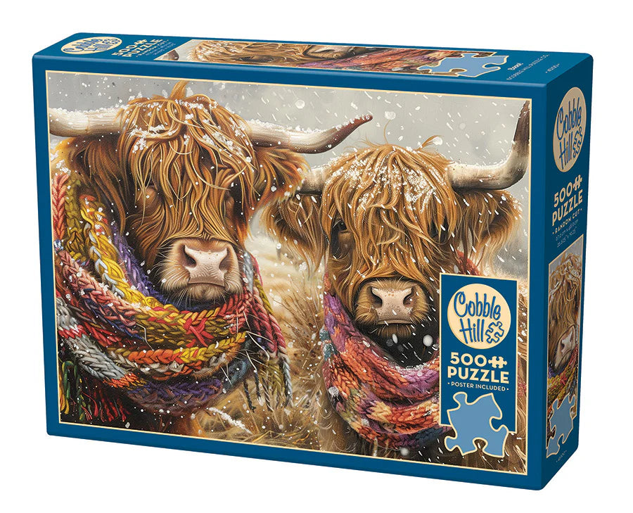 Brrrr! - 500 Piece
From Cobble Hill
Get cozy with two Highland cows in this charming 500 piece puzzle. Wrapped in colorful knitted scarves, their eyes peek out from the long hair covering their faces as snow gently falls in the field.