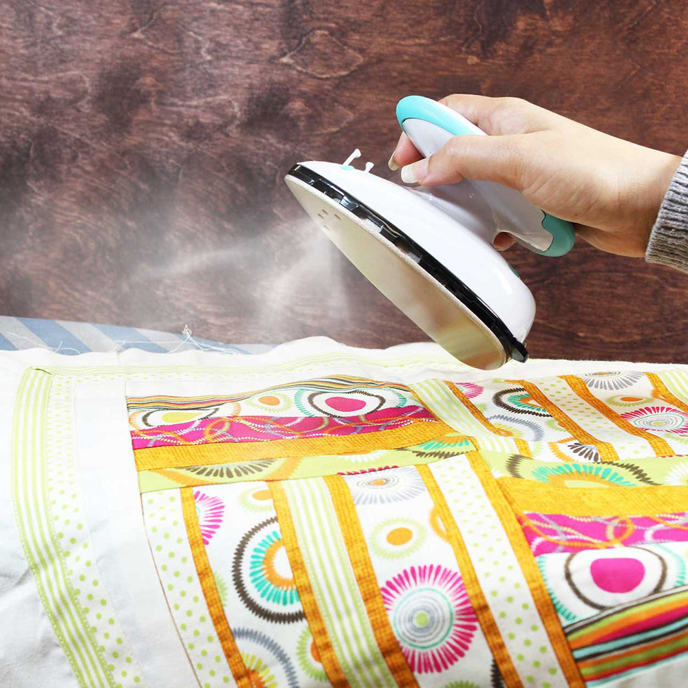Go Iron Mini Travel / Craft Iron
Exceptionally compact travel steam iron. Rubber ring around the handle for a comfortable ergonomic fit. Non-stick soleplate. Dry/continuous steam. Dual voltage 100 V - 240 V. Heats up quickly - 30 seconds. 40 ml water tank. Includes: water filling cup and storage bag.