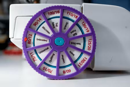 Needle Noter
From NeedleNoter
You need a Needle Noter to track which needle you left in your machine. The wheels spin to set the size and type of needle you place in your machine. Change the setting each time you change the needles.
