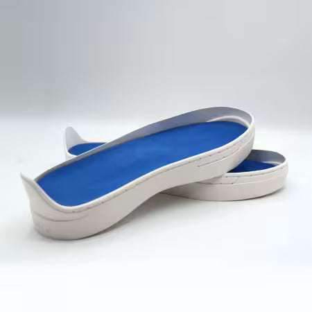 Patchwork Kicks blue shoe inserts in white rubber sneaker soles.