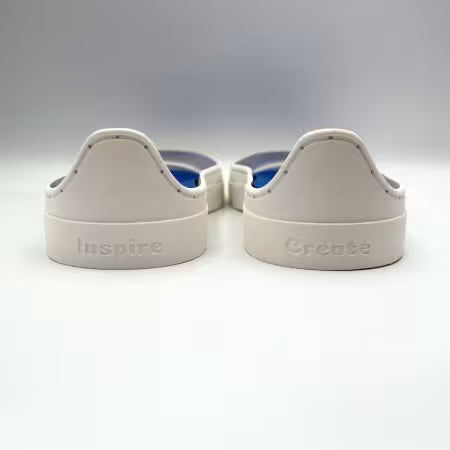 Patchwork Kicks back view of blue shoe inserts in white rubber sneaker soles.