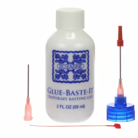 Bottle of Roxanne Glue-Baste-It temporary basting glue with needles on a white background