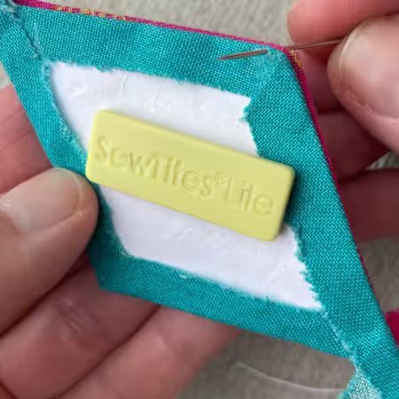 SewTites Lite Bar

From SewTites

Designed for people with arthritis and other health challenges, SewTites Lite Bars are the same size as our purple Minis, but have lower strength magnets so they're easier to slide apart. Use SewTites Lite Bars when working on EPP projects and lightweight quilting and embroidery in the hoop projects. To use, simply slide the magnet apart, align with the pieces you need to sew together, snap on the SewTites and sew. No more hand fatigue. No more working around clips and pins